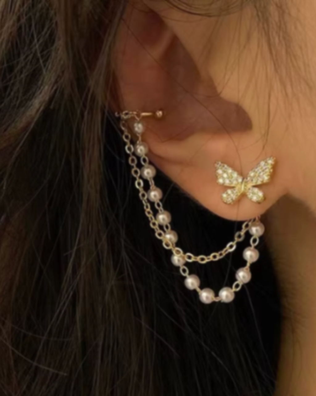 Elegant pearl tassel and butterfly chain earrings, perfect for sophisticated jewelry collections and stylish accessories.