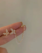 Elegant pearl tassel and butterfly chain earrings, perfect for sophisticated jewelry collections and stylish accessories.