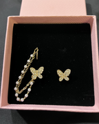 Elegant pearl tassel and butterfly chain earrings, perfect for sophisticated jewelry collections and stylish accessories.