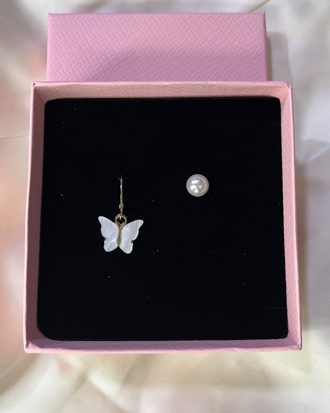 Elegant butterfly pearl earrings glistening with charm and sophistication for a timeless look